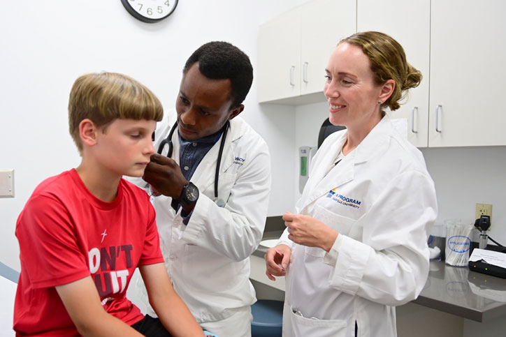 Physician Assistant giving a baby a checkup
