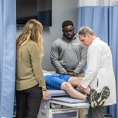 Clinical setting with patient's legs being treated.