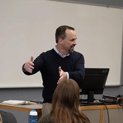 Professor in front of a classroom.