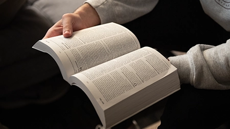 Man holding an open Bible.