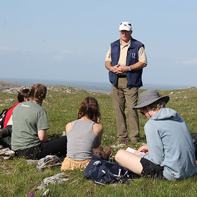 Professor leading geology students on a trip in the mountains.