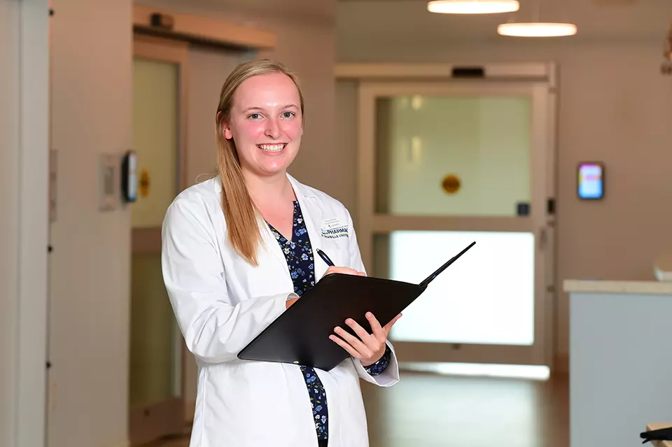 Pharmacist in white lab coat.