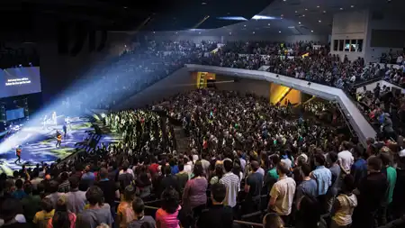 Chapel full of people and lights on stage