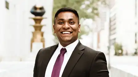 Rah alumna standing in suit