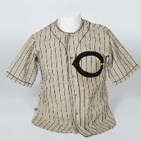 Worn baseball jersey with letter C on the left side.