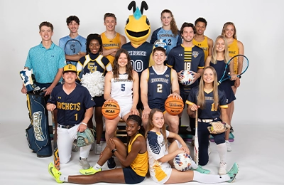 Stinger posing with an athlete from fourteen sports.