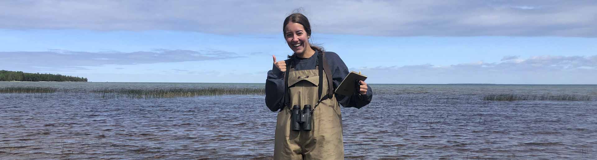 Abby Gosselink conducting research in a river.