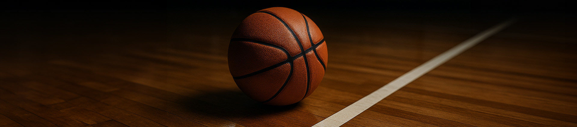 Basketball on wood court.
