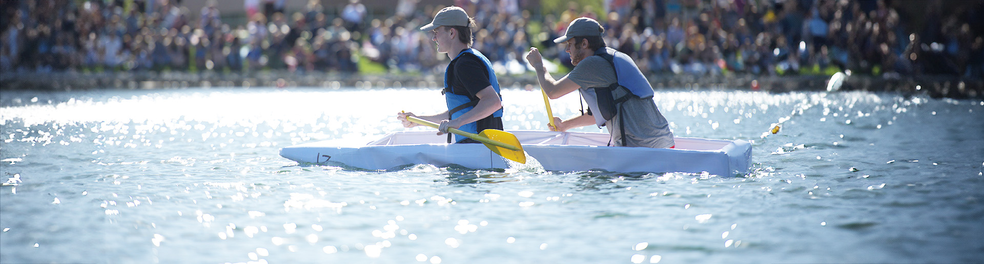 Students paddling a cardboard canoe on Cedarville University's Cedar Lake.