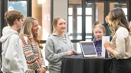 Family talking with admissions counselor.