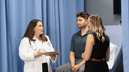 Physician Assistant professionals with student in lab.