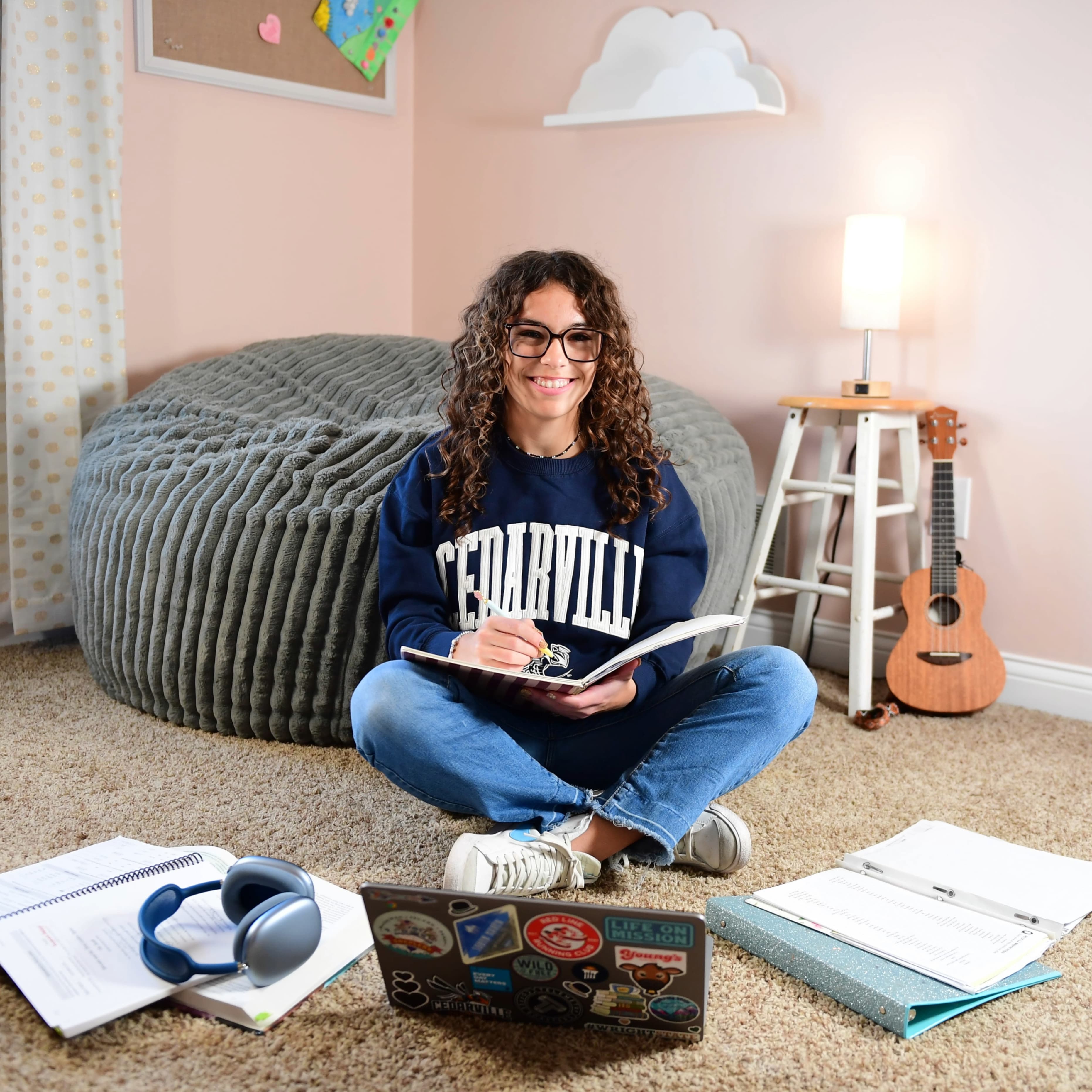 A homeschool student works on Cedarville homework in her room.