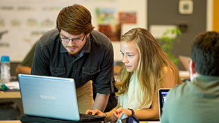 Two students working at a computer