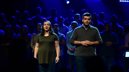 Man and woman singing duet onstage