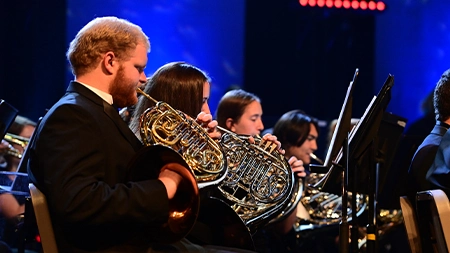 Group of french horn players performing in the Wind Symphony