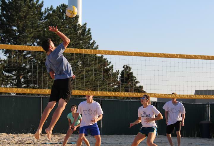Students participate in sand volleyball