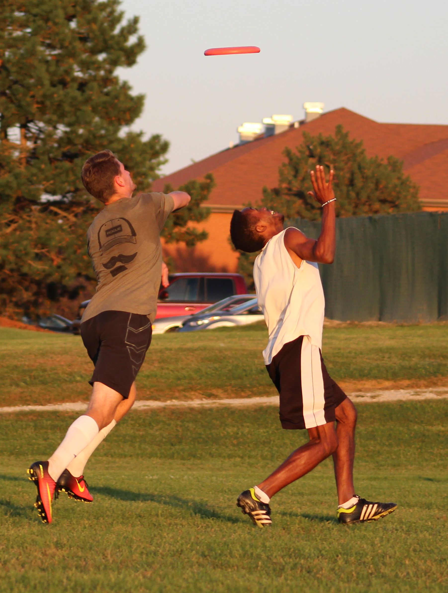 Two students catch an ultimate frisbee