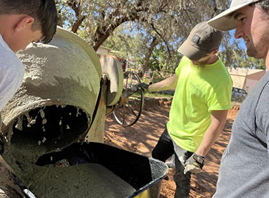 Men working with concrete mixer