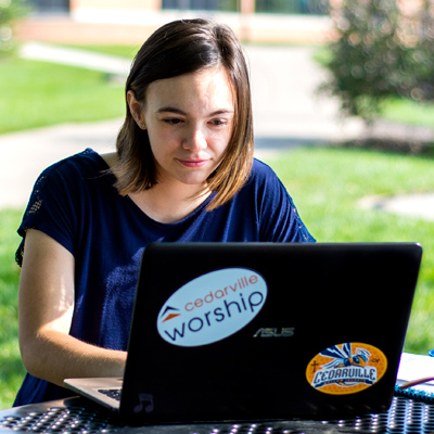 Female student pays her deposit on a computer