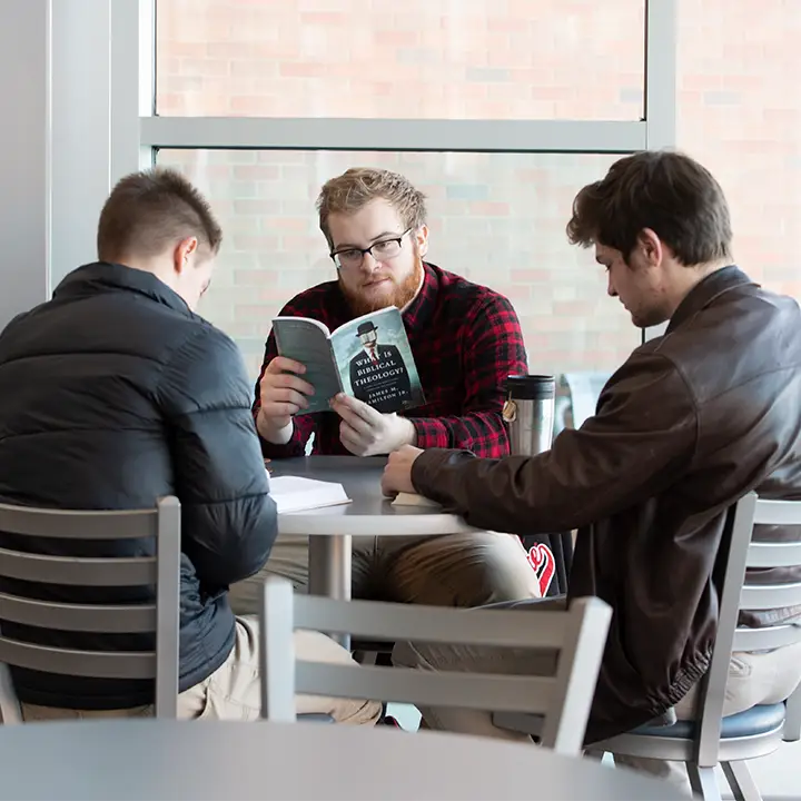 Three people seated at a table
