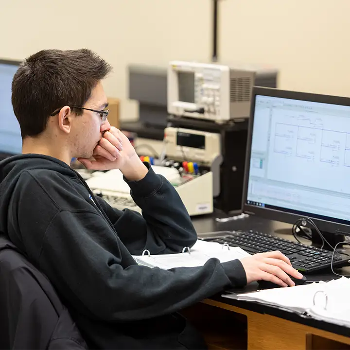 Man staring at computer screen.