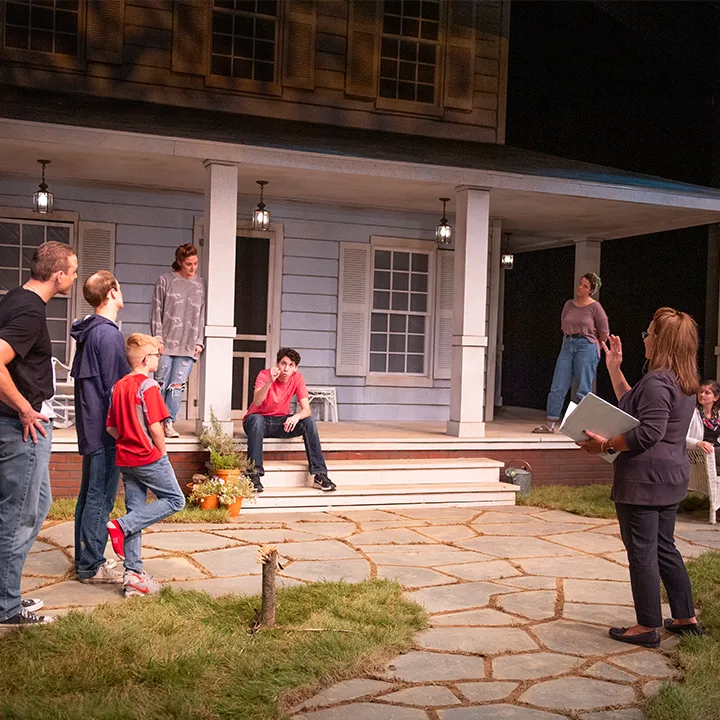 Professor Stratton leading a theatre rehearsal onstage.