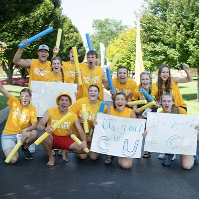 Students holding welcome signs
